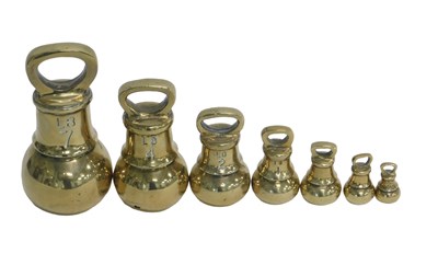 Lot 1120 - A set of seven brass weights, ranging from 7lb...