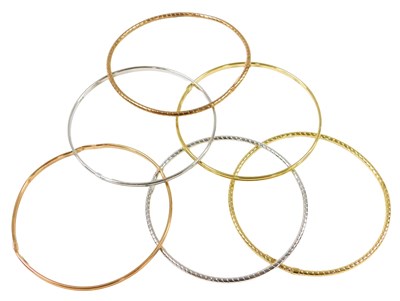 Lot 424 - Six 9ct three colour gold bangles, with double...
