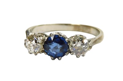Lot 221 - A platinum three stone sapphire and diamond...