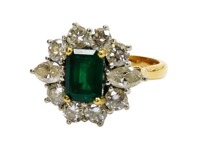 Lot 218 - An 18ct gold emerald and diamond round cluster...