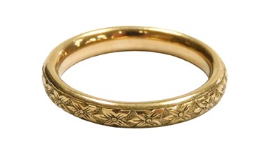 Lot 415 - A 9ct gold wedding band, with a floral...