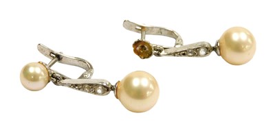 Lot 223 - A pair of bar drop earrings, each set with...