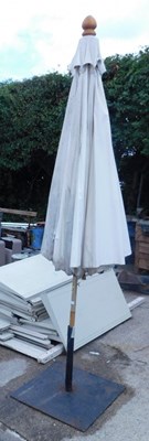 Lot 1671A - A white canvas outdoor patio umbrella and...