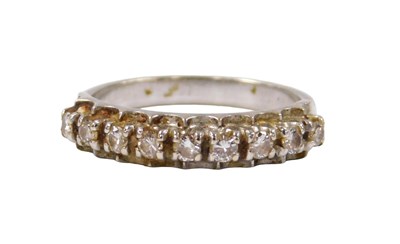 Lot 529 - A diamond nine stone ring, in a raised single...
