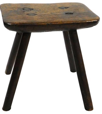 Lot 391 - A 19thC elm milking stool, raised on four...