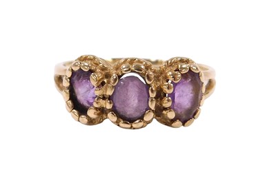 Lot 537 - A 9ct gold and amethyst three stone ring, each...