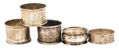 Lot 116 - Five silver napkin rings, three with engraved...