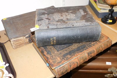 Lot 2115 - Three leather bound Bibles, one dating from...