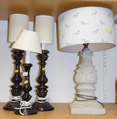 Lot 2083 - A pair of carved wooden table lamps, with...