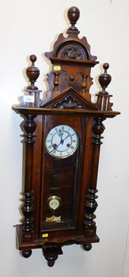 Lot 2085 - A walnut cased Vienna wall clock, the white...