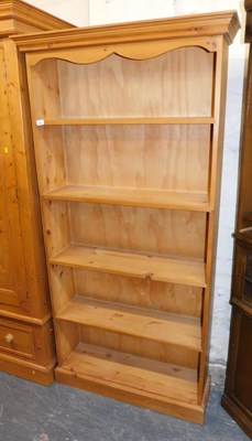 Lot 1001 - A pine open bookcase, the top with a moulded...