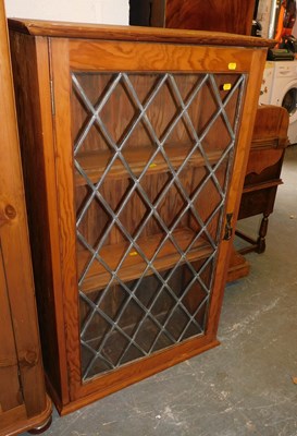 Lot 1064 - A pine display cabinet, the front with a...