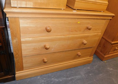 Lot 1004 - A contemporary oak chest of three long drawers,...
