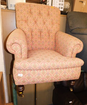 Lot 1019 - An upholstered button back armchair, in floral...