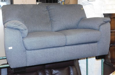 Lot 1021 - A grey upholstered two-seater sofa. 
The...