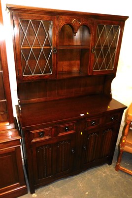Lot 1024 - An oak Old Charm style dresser, the top with...