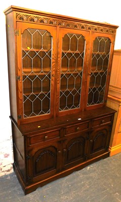 Lot 1032 - An oak display cabinet, the top with a floral...