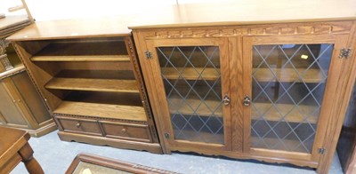 Lot 1033 - An oak open bookcase, the top with three...