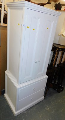 Lot 1038 - A white painted child's wardrobe, the top with...