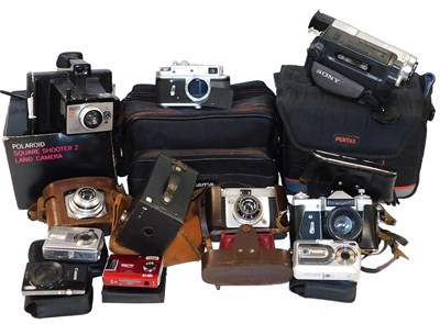 Lot 683 - A collection of cameras, comprising a Polaroid...