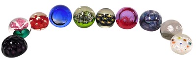 Lot 673 - Twelve 20thC glass paperweights, comprising a...