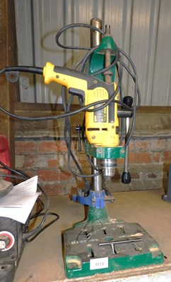Lot 1113 - A drill stand, containing a Dewalt electric...