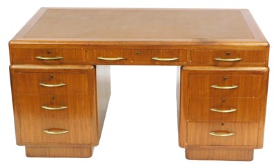 Lot 774 - A 1950s walnut kneehole desk, with leatherette...