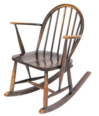 Lot 780 - An Ercol child's dark elm rocking chair.