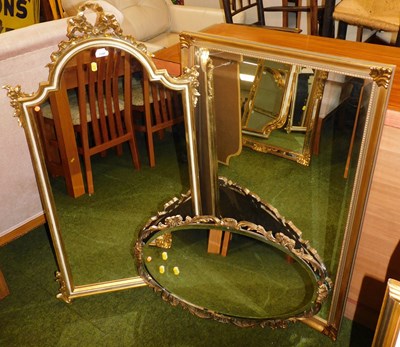 Lot 1145 - Three gilt wall mirrors, one oval, another...