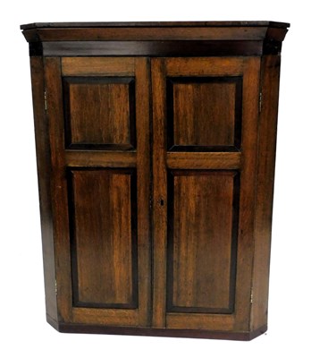 Lot 808 - A Georgian oak and rosewood banded wall...