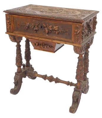 Lot 337 - A Continental carved walnut work table,...