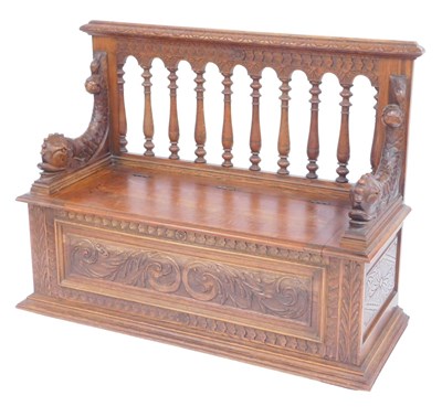 Lot 343 - A late 19thC carved oak settle, the back with...