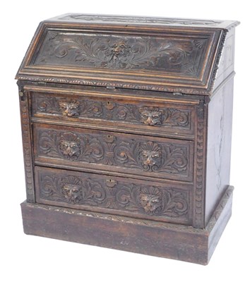 Lot 363 - A Continental carved oak bureau, the panelled...