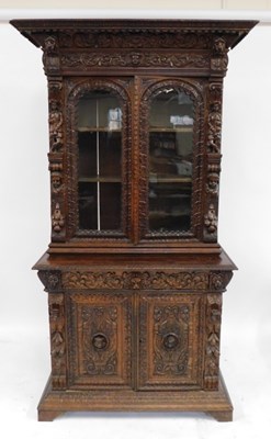 Lot 400 - A late 19thC carved oak bookcase, the cornice...