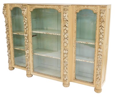 Lot 408 - A late 19thC cream painted breakfront bookcase...