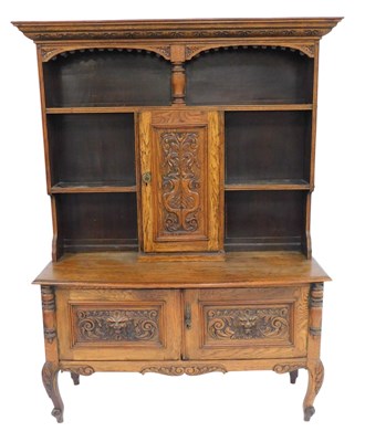 Lot 412 - An early 20thC carved oak dresser, the raised...