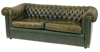 Lot 430 - A vintage distressed green leather two seater...