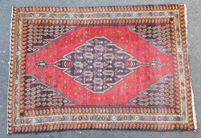 Lot 443 - A Persian Mazlaghan rug, red ground with a...