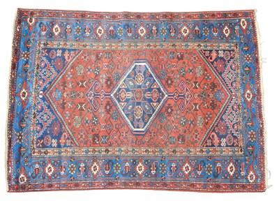 Lot 444 - A Persian Hamadan rug, red ground with a...