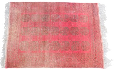 Lot 447 - A Baluch rug, red ground, with three rows of...