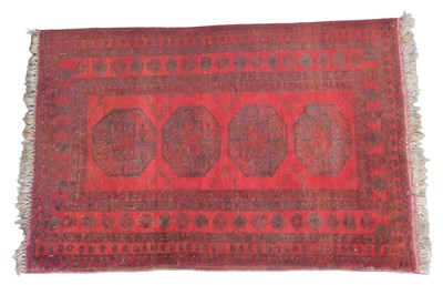 Lot 450 - An Afghan Turkomen rug, red ground, decorated...