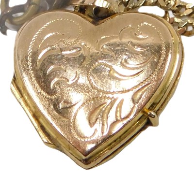 Lot 55 - A locket pendant and chain, the engraved heart...