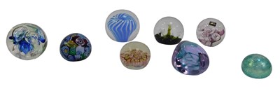 Lot 477 - A group of glass paperweights, to include a...