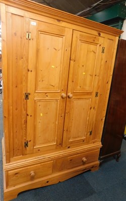 Lot 1003 - A pine wardrobe, the top with a moulded...