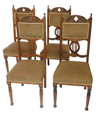 Lot 517 - A set of four Art Nouveau style oak dining...