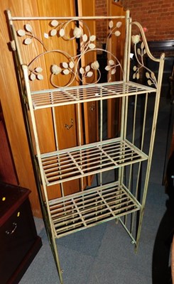 Lot 1025 - A folding metalwork four tier bookcase, with...