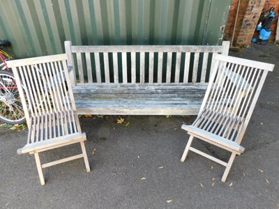 Lot 1112 - A wooden garden bench, with slatted seat and...