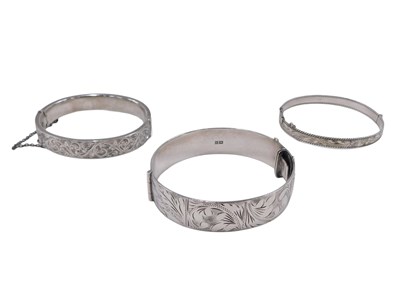 Lot 71 - Three white metal bangles, comprising a half...