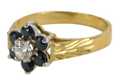 Lot 250 - A floral cluster ring, set with imitation blue...