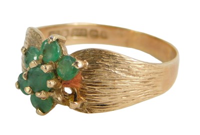 Lot 254 - A 9ct gold cluster ring, set with a central...